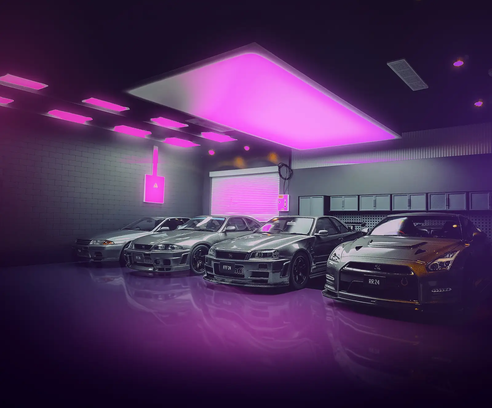 Nissan GT-R cars under pink neon lights in a garage